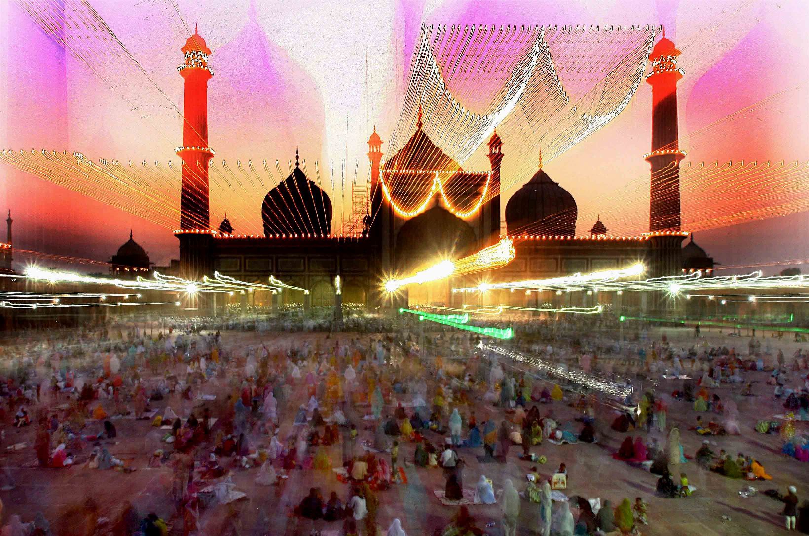 Muslims during a Roza Iftaar party at the historical Jama Masjid, illuminated ahead of Id-ul-Fitr festival, in New Delhi.Photo by Kamal Kishore